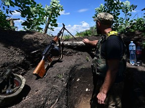 A Ukrainian soldier is pictured in a trench near the front line in eastern Ukraine on July 13, 2022, amid the Russian invasion of Ukraine.
