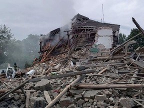 This handout picture taken and released by Ukrainian Emergency service on July 16, 2022, shows firefighters removing rubble from a destroyed building after a missile strike in the city of Nikopol, Dnipro region, amid the Russian invasion of Ukraine. AFP PHOTO / UKRAINIAN EMERGENCY SERVICE