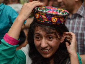 Samina Baig, the first Pakistani woman climber to summit the world's highest peak Mount Everest, gestures on her arrival at Banezir airport in Islamabad.