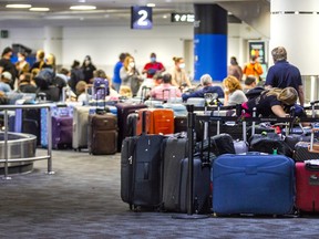 People search for their bags among unclaimed luggage at Toronto Pearson International Airport on July 5, 2022.