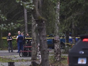 Law enforcement officers investigate the scene of a shooting in Centennial Park campground in Anchorage, Alaska, Wednesday, July 20, 2022.