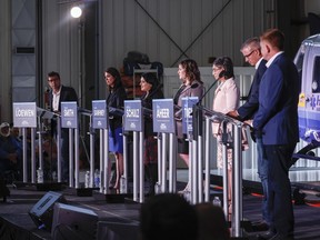 Candidates, left to right, Todd Loewen, Danielle Smith, Rajan Sawhney, Rebecca Schulz, Leela Aheer, Travis Toews, and Brian Jean, attend the United Conservative Party of Alberta leadership candidate's debate in Medicine Hat, July 27, 2022.