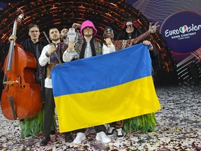 FILE - Kalush Orchestra from Ukraine celebrate after winning the Grand Final of the Eurovision Song Contest at Palaolimpico arena, in Turin, Italy, Saturday, May 14, 2022. Next year's Eurovision Song Contest will be staged in Britain, organizers announced Monday, July 25, 2022 saying it is too risky to hold it in the designated host country, Ukraine. The U.K. said the 2023 pop extravaganza would be a celebration of Ukrainian culture and creativity.