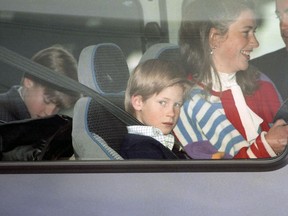Britain's Prince William and Prince Harry travel with their nanny Tiggy Legge-Bourke, at London Heathrow Airport, Oct. 26, 1993.