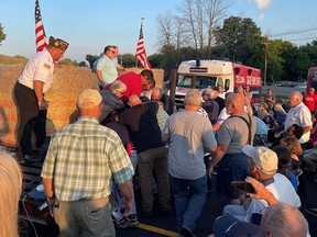 A group of people, attending Congressman Lee Zeldin's stump speech, gather around, what the photographer says was the attacker, after an alleged attack on Zeldin during his stump speech, in Fairport, New York, July 21, 2022.