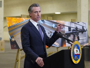 FILE - California Gov. Gavin Newsom speaks to reporters at Del Mar Fairgrounds on Feb. 18, 2022, in Del Mar, Calif. Newsom announced Friday, July 22, he will sign a controversial, first-in-the-nation gun control law patterned after a Texas anti-abortion law.