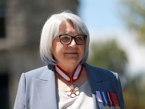 Gov. Gen. Mary May Simon inspects members of the Guard of Honour at legislature in Victoria on Friday, May 20, 2022. Simon says Canadians should work together to build an inclusive society in her official message to the nation to mark Canada Day.