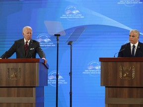 U.S. President Joe Biden, left, gives a press conference with Israel's Prime Minister Yair Lapid, at the Waldorf Astoria Hotel in Jerusalem, Thursday, July 14, 2022.