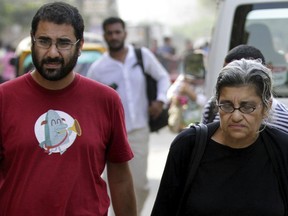 FILE - Alaa Abdel Fattah, left, a leading Egyptian pro-democracy activist walks with his mother Laila Soueif, a university professor who is an also an activist, outside a court, in Cairo, Egypt, Oct. 26, 2014. A leading human rights watchdog on Thursday, July 28, 2022, urged Egyptian authorities to allow the family of a jailed activist access to him and reiterated calls for his immediate release. For nearly 10 days, Abdel-Fattah's family members had not received any word from him and were told by prison officials that he is refusing to meet with them, Amnesty International reported.