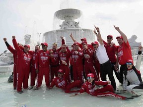 Chip Ganassi engineer Angela Ashmore is shown sitting in the water, second from bottom right, next to Nicole Rotondo, an engineer with Honda Performance Development, bottom far right, as the team celebrates in a fountain after Marcus Ericsson of Sweden won the first race of the IndyCar Detroit Grand Prix auto racing doubleheader on Belle Isle in Detroit on Saturday, June 12, 2021.