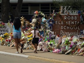 n this July 12, 2022, photo, Visitors walk past a makeshift memorial honoring those killed at Robb Elementary School, in Uvalde, Texas. Parents in Uvalde, Texas, are livid about the security lapses that contributed to the school shooting this spring. They're terrified to send their kids back to school. Yet further securing schools -- such as through additional lockdown drills -- is controversial.