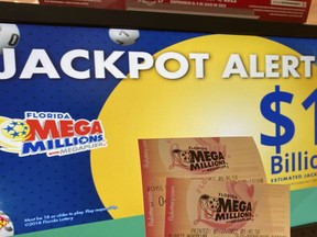 FILE - In this Wednesday, July 27, 2022 file photo, Mega Millions lottery tickets are shown at a lottery retailer in Surfside, Fla. A giant Mega Millions lottery jackpot ballooned to over $1 billion after no one matched all six numbers and won the top prize.