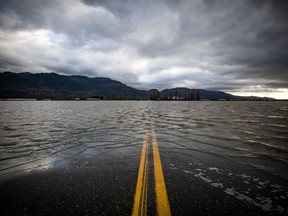 Floodwaters cover a road that runs through farmland in Abbotsford, B.C., Tuesday, Nov. 23, 2021. The River Forecast Centre has downgraded its recent flood watch for the Upper Fraser River, issued Wednesday, back to a high streamflow advisory.