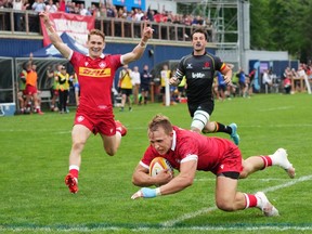 Canada's Ben LeSage, right, scores a try in front of teammate Cooper Coats, left, and Belgium's Basile Poupaert during the second half of a men's 15s international rugby test match in Halifax on Saturday, July 2, 2022.