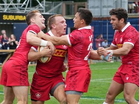 Canada's Ben LeSage, second from left, celebrates scoring a try with teammates, from left to right, Cooper Coats, Ross Braude, and Dawson Fatoric during the second half of a men's 15s international rugby test match against Belgium in Halifax on July 2, 2022.