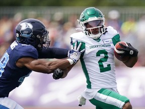 Saskatchewan Roughriders' Mario Alford, right, avoids a tackle by Toronto Argonauts' Wynton McManis during the first half of CFL action at Acadia University in Wolfville, N.S., Saturday, July 16, 2022.&ampnbsp;McManis returned an interception 50 yards for a touchdown in a separate play to rally the Toronto Argonauts to a 30-24 win over the Saskatchewan Roughriders in an entertaining but often chippy Touchdown Atlantic game Saturday afternoon.