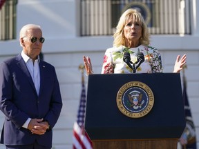President Joe Biden listens as first lady Jill Biden speaks during a Fourth of July celebration for military families on the South Lawn of the White House, Monday, July 4, 2022, in Washington.