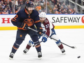 Colorado Avalanche's J.T. Compher (37) and Edmonton Oilers' Duncan Keith (2) battle for the puck during third period NHL conference finals action in Edmonton on Monday, June 6, 2022. The defenceman Duncan Keith is retiring, a source has told
