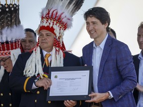Prime Minister Justin Trudeau, right, and Siksika Nation Chief Ouray Crowfoot participate in a signing ceremony on the Siksika Nation in Siksika Nation, Alta., Thursday, June 2, 2022.THE CANADIAN PRESS/Jeff McIntosh