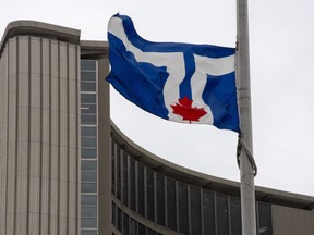 The city of Toronto flag flies at half mast to mourn the death of Prince Phillip, at City Hall in Toronto on April 9, 2021. Security contractors with the City of Toronto will accommodate and rehire Sikh employees who were removed from their positions due to a conflict between their facial hair required by their religion and COVID-19 rules, the city said in a statement on Tuesday.