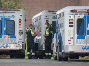 Paramedics stand by their ambulances at Toronto Western Hospital in Toronto on Tuesday October 27, 2020.