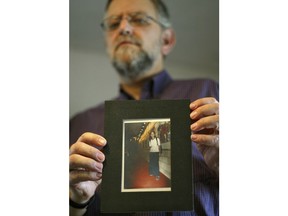 FILE - Arnold Roth holds a photo of his 15-year-old daughter Malki, who was killed in an August 2001 Palestinian suicide bombing at a Jerusalem pizzeria, at his house in Jerusalem, on Sept. 28, 2004. The family of an Israel-American girl killed in a 2001 Palestinian suicide bombing in Jerusalem is seeking a meeting with President Joe Biden in hopes of forcing Jordan to extradite Tamimi, who was convicted in the deadly attack. The parents of Malki Roth sent a letter to the White House on Sunday, July 10, 2022 asking to meet with Biden when he comes to Jerusalem this week. They want the president to put pressure on Jordan, a close American ally, to send Tamimi to the U.S. for trial.