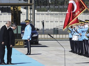 Italy's Prime Minister Mario Draghi, second left, and Turkey's President Recep Tayyip Erdogan review an honour guard prior their meeting at the Turkish Presidential palace in Ankara, Turkey, Tuesday, July 5, 2022. Draghi is on an official visit to Turkey. (AP Photo)