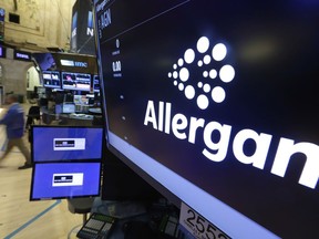 FILE - The Allergan logo appears above a trading post on the floor of the New York Stock Exchange on Nov. 23, 2015. Opioid makers Allergan and Teva have agreed to pay $54 million in cash and overdose reversal drugs to settle a federal lawsuit brought by San Francisco, in an agreement announced Tuesday, July 12, 2022. The city alleges the drug industry fueled an overdose and addiction surge in San Francisco that created a public nuisance.