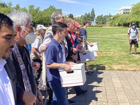 Backers of a proposed initiative that would require individuals to secure permits to buy firearms and ban large-capacity magazines deliver the signatures of thousands of voters on Friday, July 8, 2022, to state election offices in Salem, Oregon. The backers say concern about recent mass shootings have buoyed their effort and that they have enough signatures to place the measure on the November ballot.