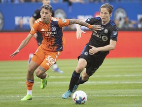 CF Montreal's Lassi Lappalainen, right, challenges New York City FC's Gabriel Pereira during first half MLS soccer action in Montreal, Saturday, July 30, 2022.
