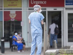 A health-care worker is shown outside a hospital in Montreal, Thursday, July 14, 2022, as the COVID-19 pandemic continues in the province.