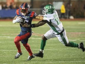 Saskatchewan Roughriders' Larry Dean (11) attempts a tackle on Montreal Alouettes' Walter Fletcher during second half CFL football action in Montreal, Thursday, June, 23, 2022.