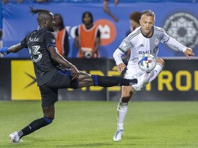 CF Montreal's Kei Kamara, left, challenges Toronto FC's Domenico Criscito during second half MLS soccer action in Montreal, Saturday, July 16, 2022.