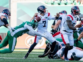Saskatchewan Roughriders defensive lineman Anthony Lanier II (91) forces Montreal Alouettes quarterback Trevor Harris (7) to fumble the ball during first half CFL football action in Regina, on Saturday, July 2, 2022.
