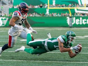 Montreal Alouettes linebacker Tre Watson (33) looks on as Saskatchewan Roughriders wide receiver Justin McInnis (18) dives for a catch during second half CFL football action in Regina on July 2, 2022. Watson joined the Edmonton Elks practice roster Wednesday. He was released by Montreal on Monday after starting in the Alouettes' first four games of the season.