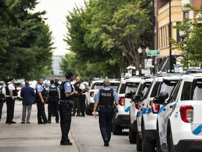 Chicago police investigate in the 1300 block of West Taylor Street after officials said an officer was shot multiple times while responding to a call of a domestic disturbance in a University Village neighborhood apartment building, Friday morning, July 1, 2022, in Chicago.