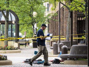 Members of the FBI's Evidence Response Team Unit investigate on Central Avenue near Green Bay Road in downtown Highland Park, Ill., less than 24 hours after a gunman killed several people and wounded dozens more by firing a high-powered rifle from a rooftop onto a crowd attending Highland Park's Fourth of July parade, Tuesday morning, July 5, 2022.