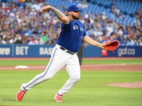 Toronto Blue Jays starting pitcher Alek Manoah throws to first base to put out Detroit Tigers' Jeimer Candelario in the second inning of American League baseball action in Toronto, Friday, July 29, 2022.