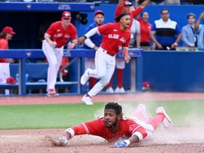 Toronto Blue Jays' Raimel Tapia slides safely into home plate on a walk-off single by Teoscar Hernandez to win the game in the bottom of 10th inning American League baseball action in against the Kansas City Royals Toronto, Saturday, July 16, 2022.