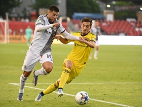 Toronto FC forward Alejandro Pozuelo, left, works the ball past Columbus Crew forward Pedro Santos during first half MLS soccer action in Toronto on June 29, 2022. Toronto FC has confirmed the sale of Pozuelo to Inter Miami CF.
