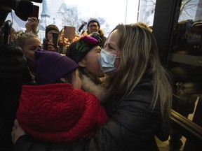 Tamara Lich, an organizer of the so-called Freedom Convoy who organized fundraising for the protest which became a weeks long blockade, embraces supporters as she leaves the courthouse in Ottawa after being granted bail, on Monday, March 7, 2022.