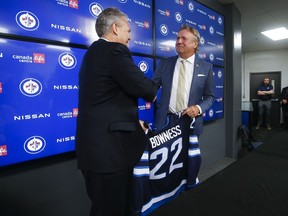 Winnipeg Jets General Manager Kevin Cheveldayoff, left, welcomes new head coach Rick Bowness to the team at a press conference in Winnipeg, Monday, July 4, 2022.