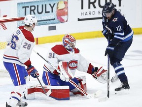 Montreal Canadiens goaltender Carey Price (31) saves a tip by Winnipeg Jets' Pierre-Luc Dubois (13) as Jeff Petry (26) defends during third period NHL playoff action in Winnipeg on Friday, June 4, 2021.&ampnbsp;Dubois says he never asked the Winnipeg Jets for a trade and comments that he wants to play in Montreal were blown out of proportion. THE&ampnbsp;CANADIAN PRESS/John Woods