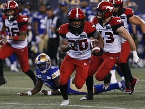 Calgary Stampeders' Peyton Logan (20) gets the first down against the Winnipeg Blue Bombers during the second half of CFL action in Winnipeg, Friday, July 15, 2022.