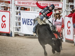Dakota Buttar, of Eatonia, Sask., rides Lil Hootch to a tie during bull riding rodeo finals action at the Calgary Stampede in Calgary, Alta., Sunday, July 17, 2022.&ampnbsp;Both Buttar and Shane Proctor posted scores of 88.5 points atop their bulls in a bonus round of action of the marquee event in front of a near capacity crowd at GMC Stadium.