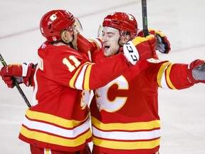 Calgary Flames forward Andrew Mangiapane, right, celebrates his goal with teammate forward Mikael Backlund during first period NHL second round playoff hockey action against the Edmonton Oilers in Calgary on May 18, 2022.