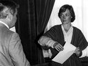 In this file photo, JoAnn Wilson, ex-wife of former Saskatchewan cabinet minister Colin Thatcher, talks to her lawyer, Gerry Gerrand, on July 13, 1981 before a press conference where she announced that she relinquished custody of his son Regan.  Wilson's arm had been in a steel splint since he was shot by an unknown man on May 17 of that year.