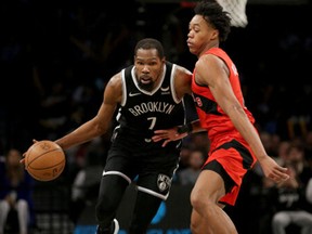 Brooklyn Nets forward Kevin Durant (7) controls the ball against Toronto Raptors forward Scottie Barnes (4) during the fourth quarter at Barclays Center in December 2021.