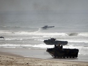 FILE - Amphibious Assault Vehicles storm Red Beach during exercises at Camp Pendleton, Calif., June 2, 2010. The U.S. Marine Corps will keep its new amphibious combat vehicle - a kind of seafaring tank - out of the water while it investigates why two of the vehicles ran into troubles off the Southern California coast this week amid high surf, military officials said Wednesday, July 20, 2022.