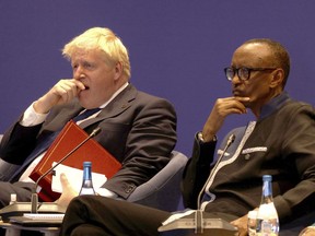 Britain's Prime Minister Boris Johnson, left, and Rwanda President Paul Kagame during the Leaders' Retreat executive session on the sidelines of the 2022 Commonwealth heads of Government meeting in Kigali, Rwanda, Saturday June 25, 2022.
